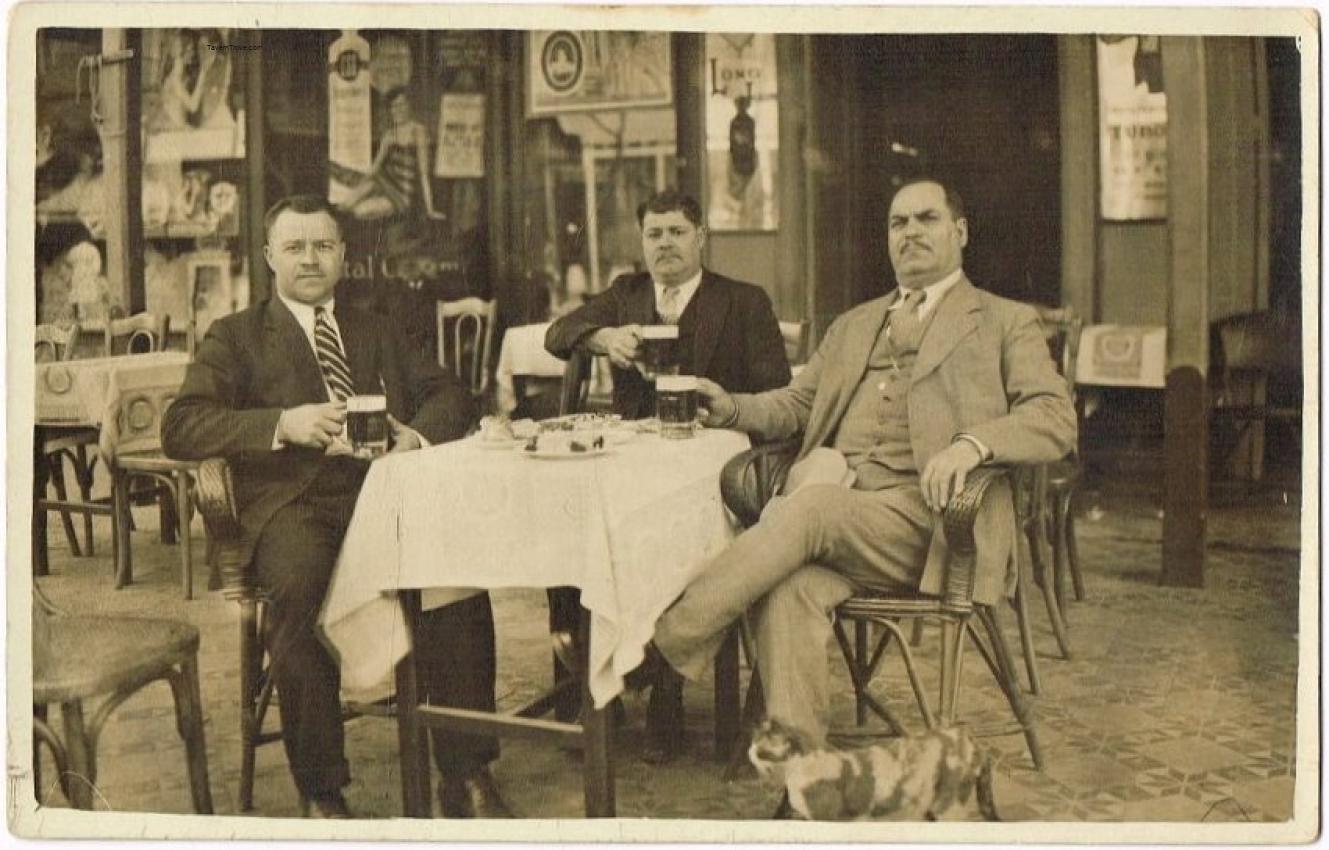 Men Drink Beer In An Outdoor Cafe